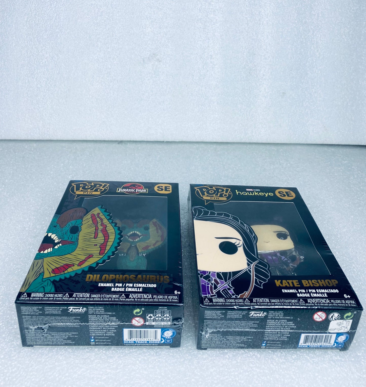 #66 - lot Of 2 - New Funko Pop Pins, Jurassic Park & Marvels Hawkeye - (READ) - (IN CONDITION AS SHOWN)
